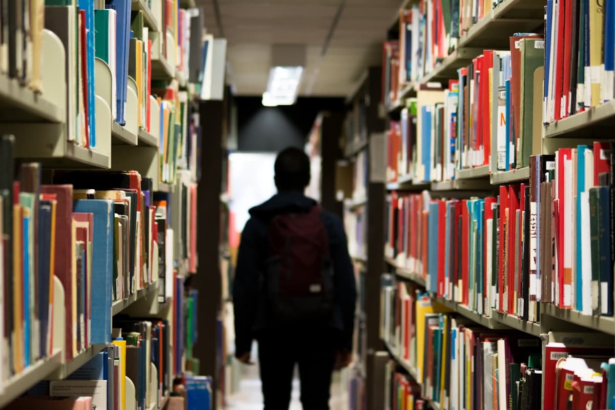 A student exploring books in a library